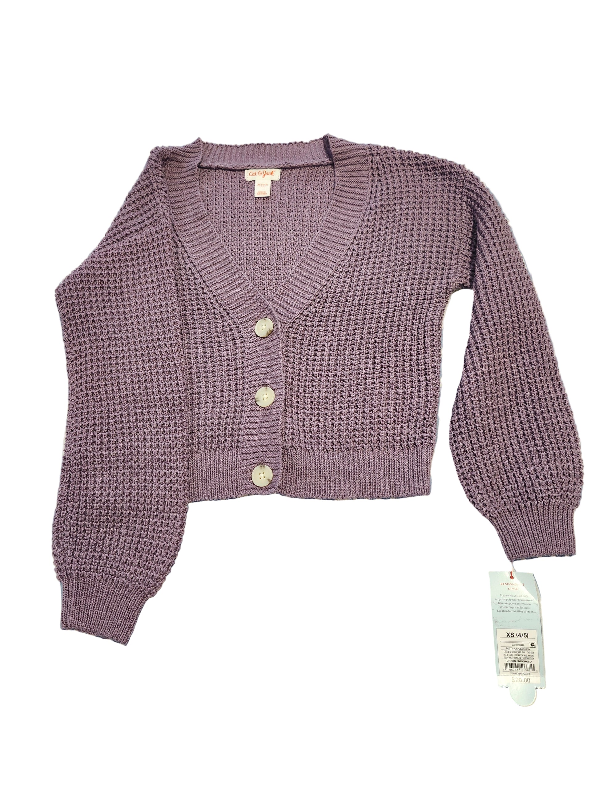 Purple knitted cardigan with buttons on a blue and white patterned surface