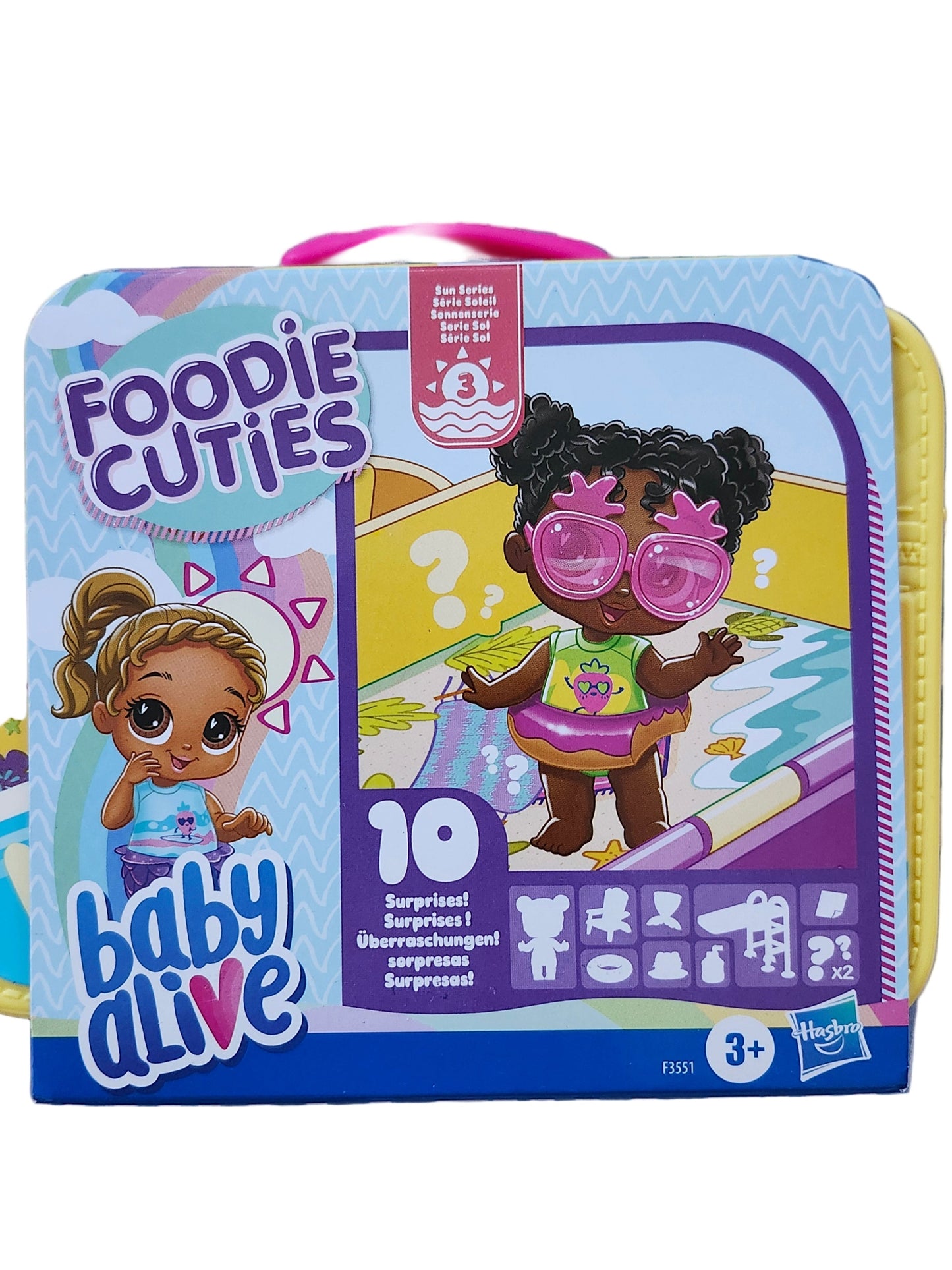 Toy packaging with 'Foodie Cuties' and 'Baby Alive' branding on a striped background