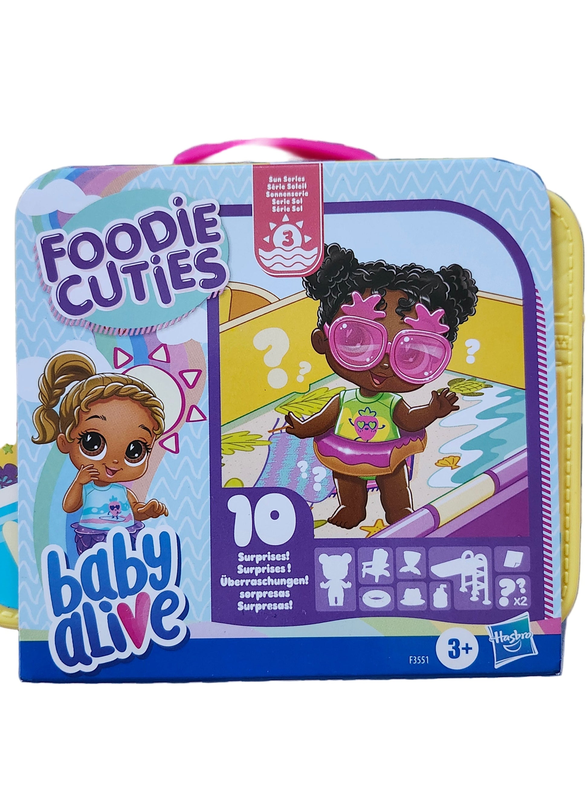 Toy packaging with 'Foodie Cuties' and 'Baby Alive' branding on a striped background