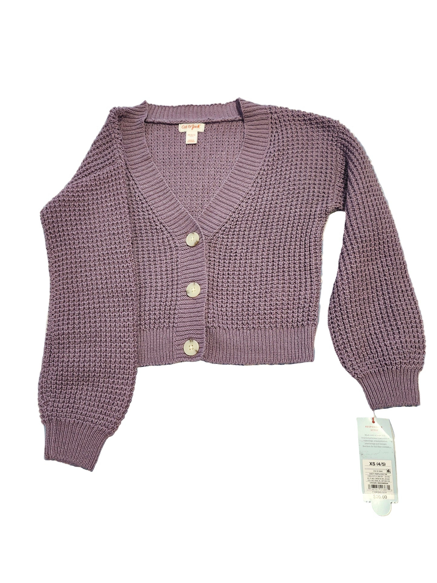 Purple knitted cardigan with buttons on a blue and white patterned surface